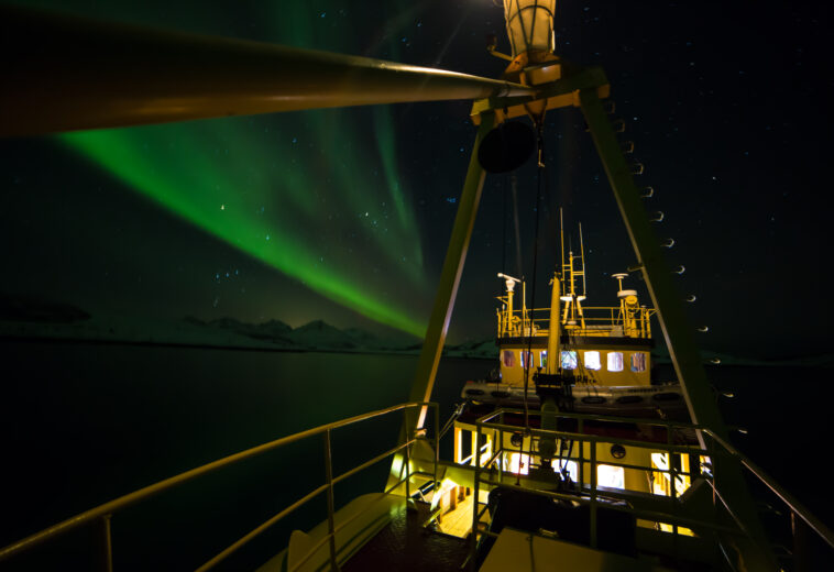 beteau en norvege avec les aurores boréales